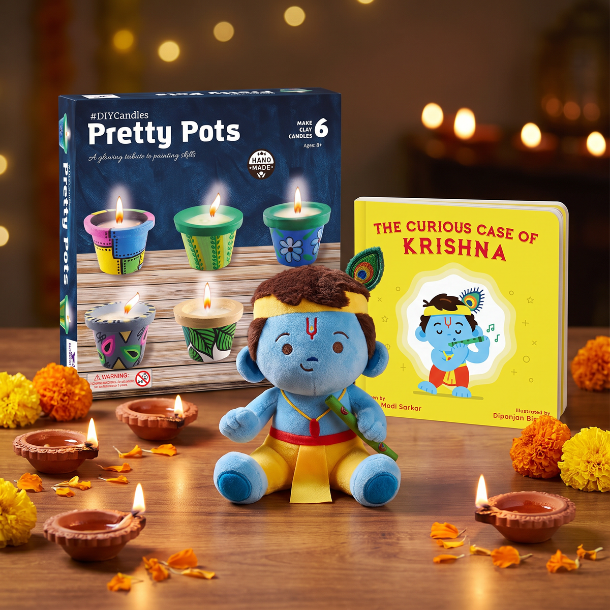 Diwali gift combo with Modi Toys Baby Krishna mantra singing plush, The Curious Case of Krishna board book and Toykraft Candles From Pretty Pots kit